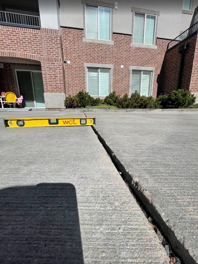 Uneven commercial walkway before lifting
