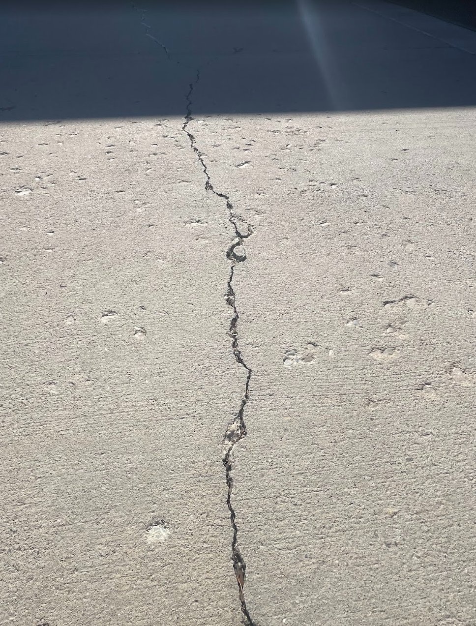 Concrete slab with a long crack running down the center before sealing