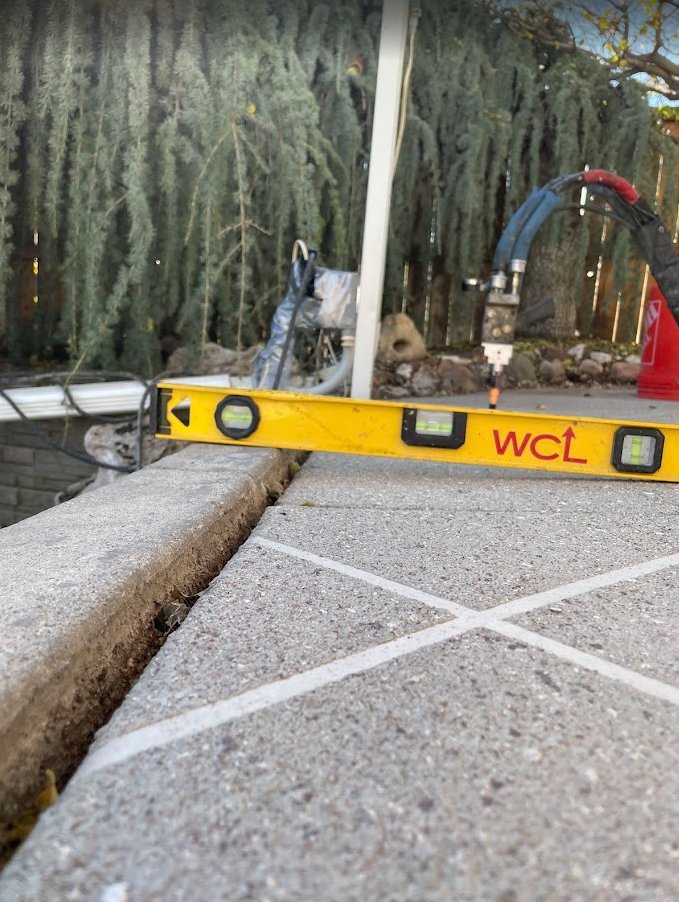 Sunken back patio in Draper below retaining wall before concrete lifting