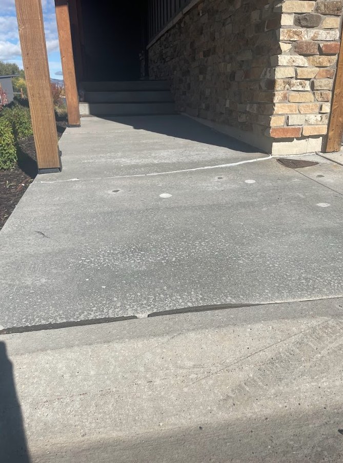 West Jordan walkway after polyjacking — small clean patch holes visible